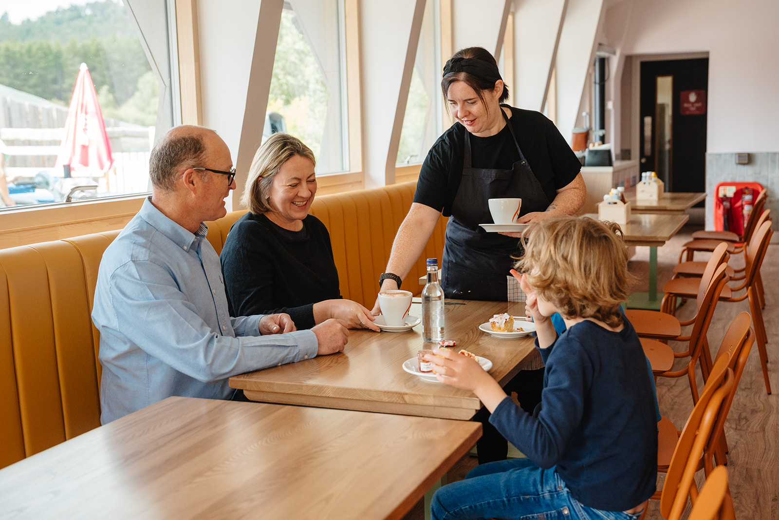 Visitors sitting at a table in Antlers Café. IMAGE: Rachel Hein July 2025