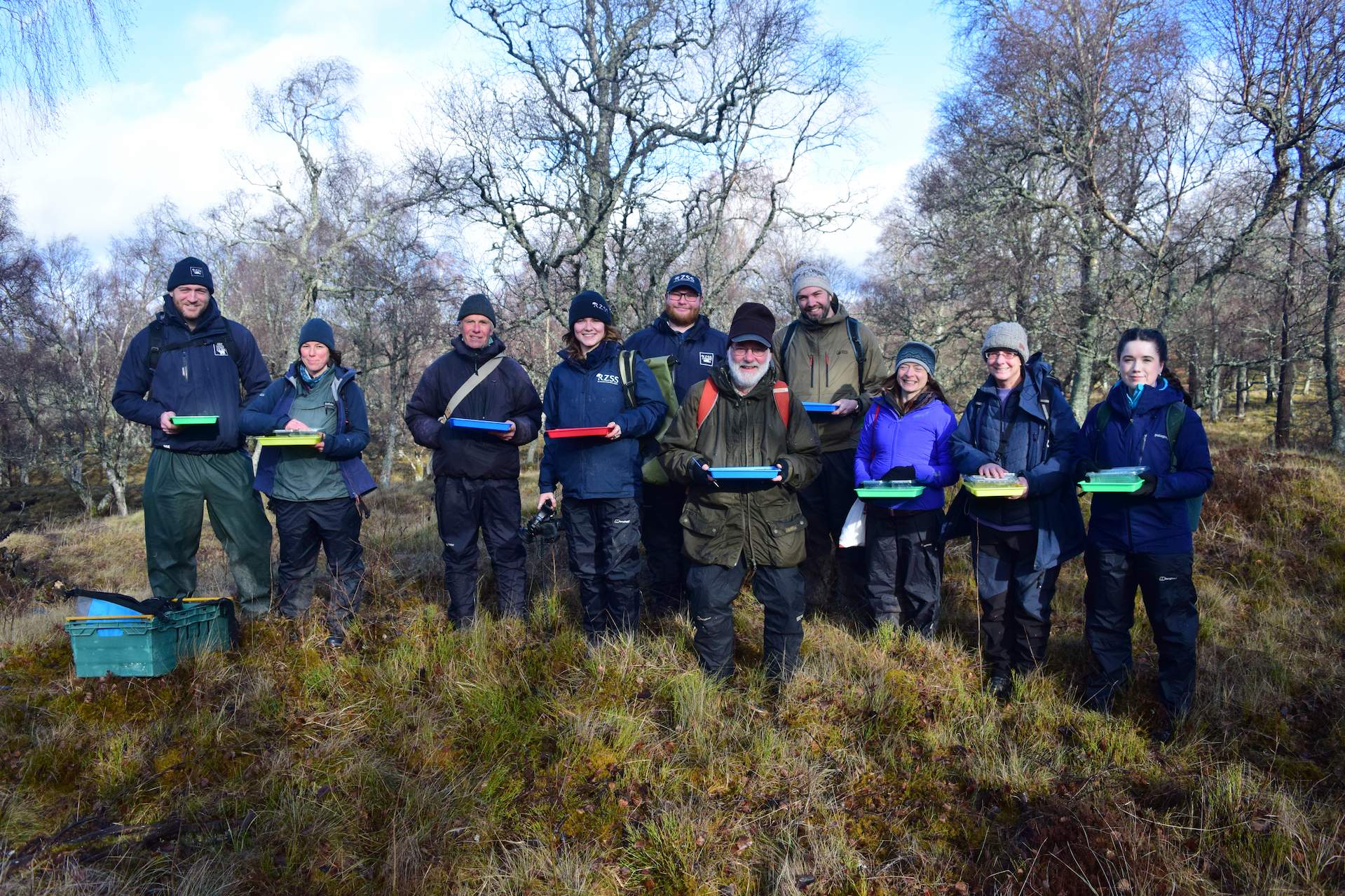 RZSS staff and Rare Invertebrates in the Cairngorms partners pose in group together with trays for dark bordered beauty moth egg releases

Image: RZSS CONSERVATION 2024