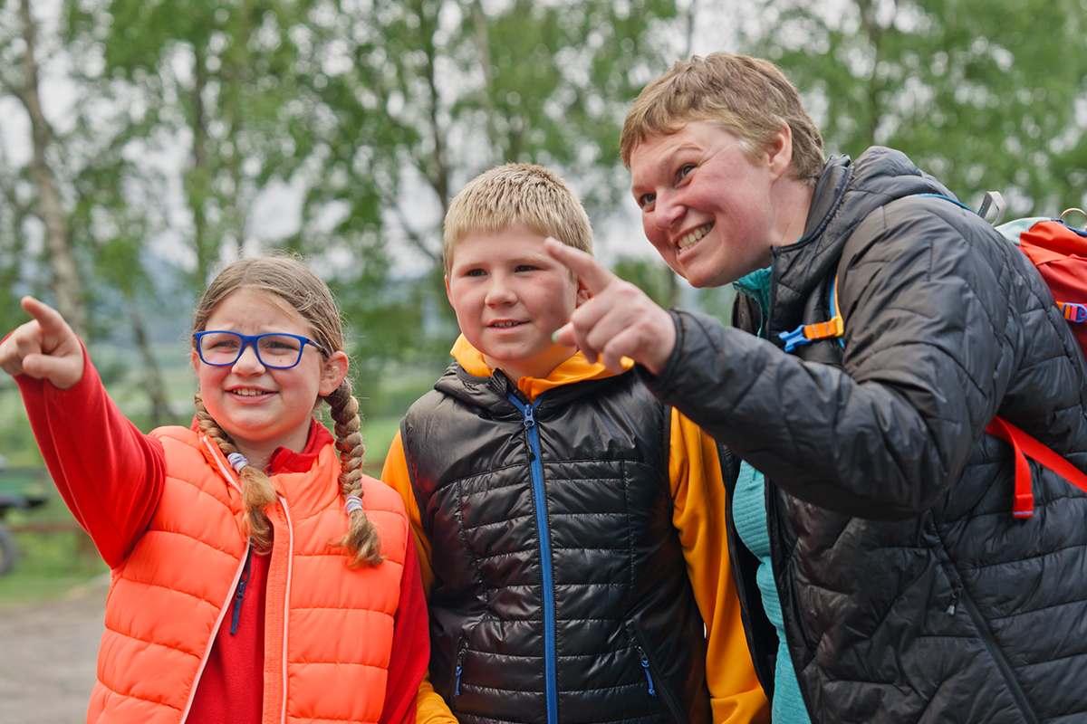 Family smiling and pointing off camera IMAGE: FoSho 2024